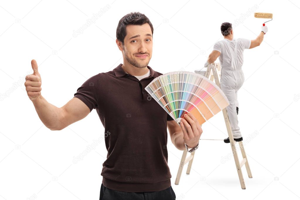 Man with a color swatch and painter on ladder