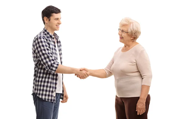 Man shaking hands with an elderly woman — Stock Photo, Image