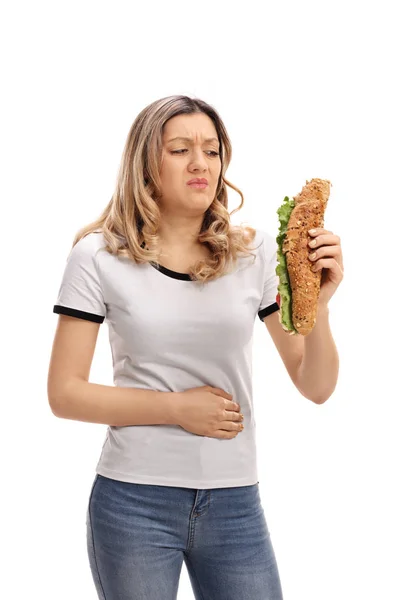 Mujer teniendo sándwich y experimentando dolor de estómago —  Fotos de Stock