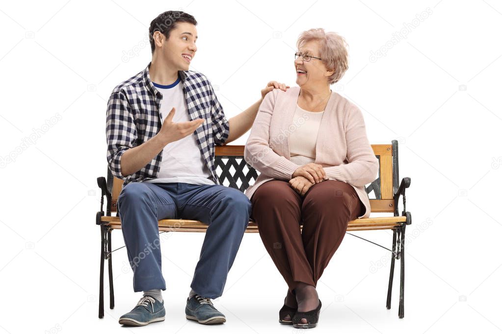 man and elderly woman sitting on bench and talking