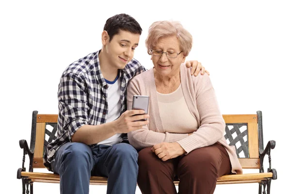 Man with mature woman showing her something on phone — Stock Photo, Image