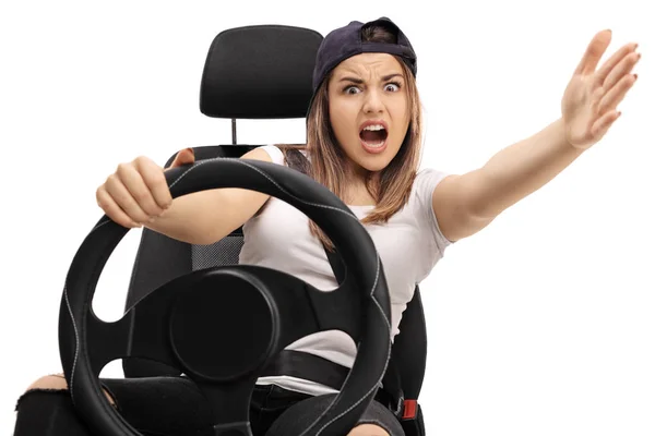 Angry teenage driver holding a steering wheel — Stock Photo, Image