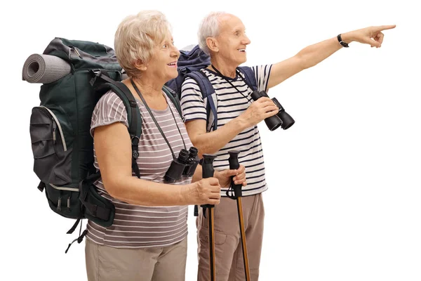 Male and female mature hiker with one of them pointing — Stock Photo, Image