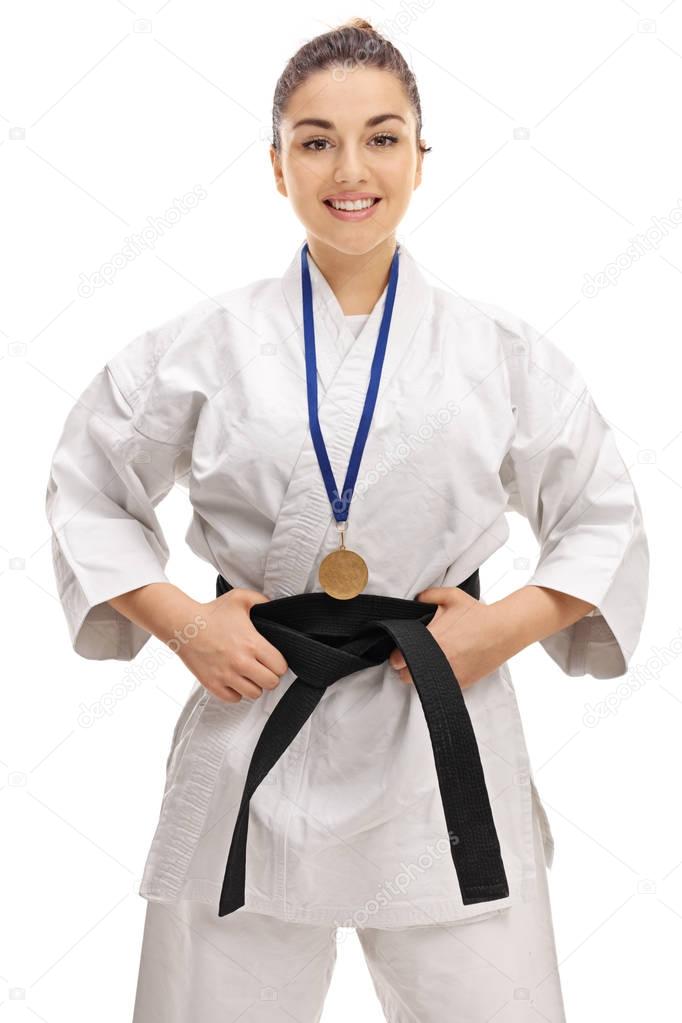 Karate girl with a gold medal smiling