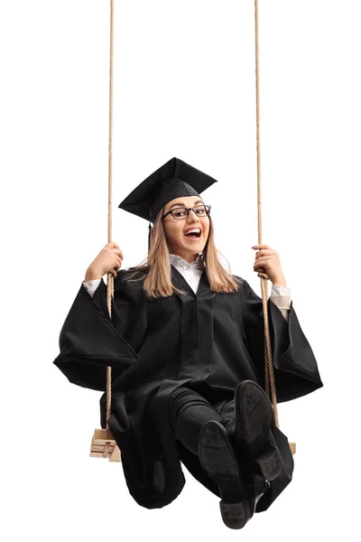 Alegre estudiante graduado balanceándose en un columpio — Foto de Stock