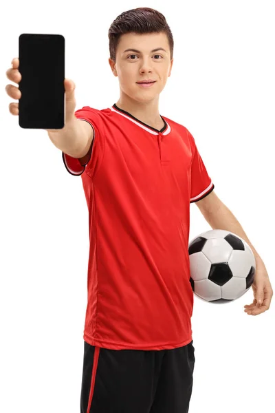 Jogador de futebol adolescente mostrando um telefone — Fotografia de Stock