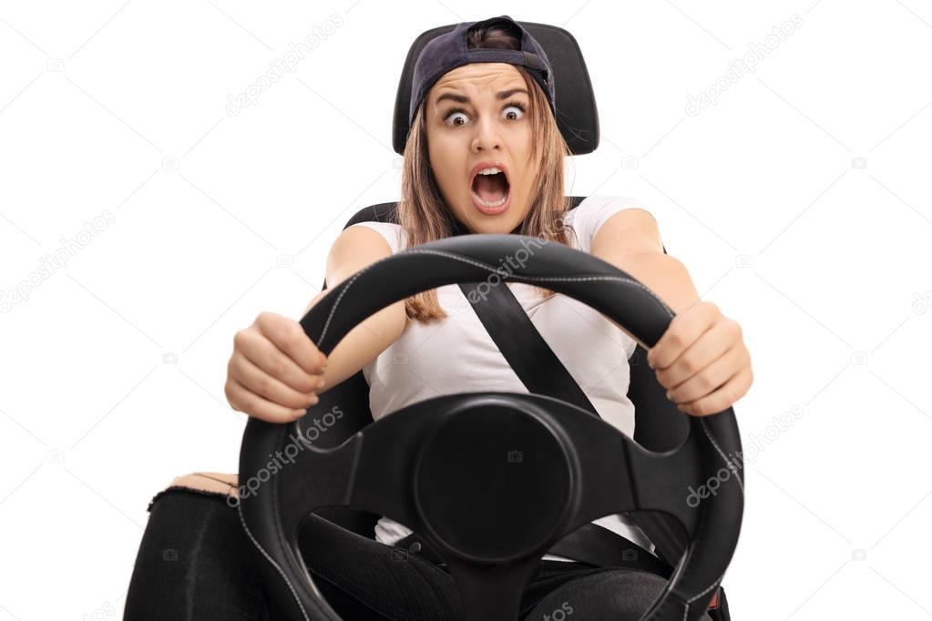 Terrified teenage girl pressing the brake pedal