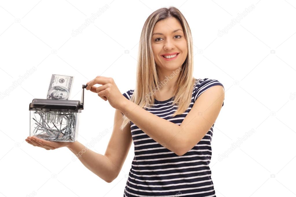 woman destroying a dollar banknote in a paper shredder