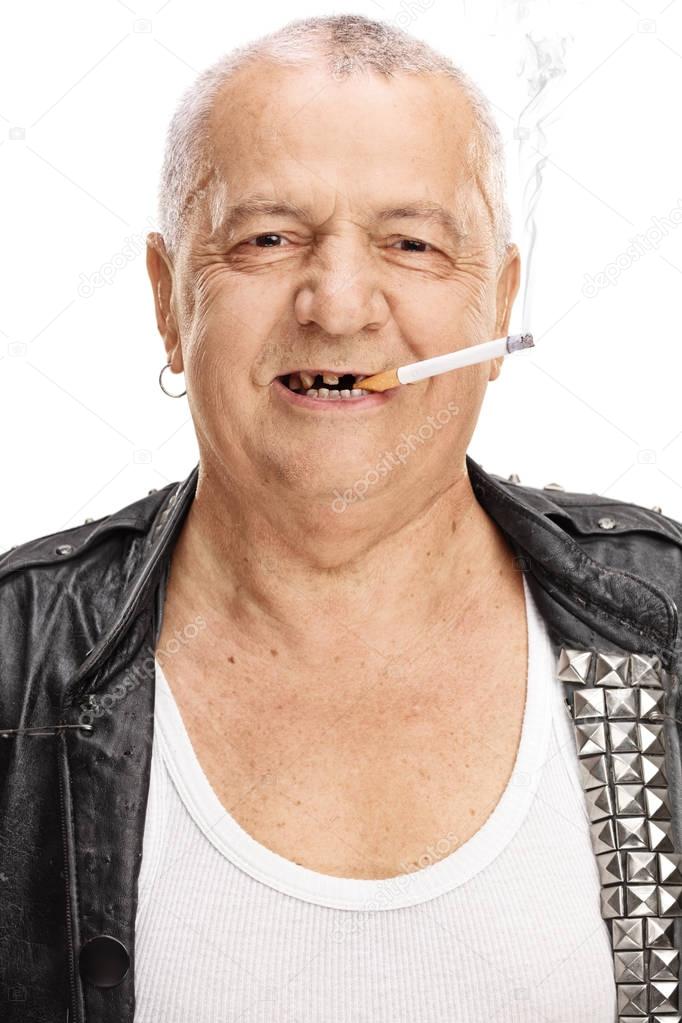 Portrait of an elderly punker with a cigarette