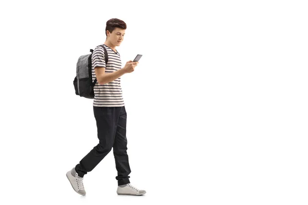 Studente adolescente che cammina e guarda un telefono — Foto Stock