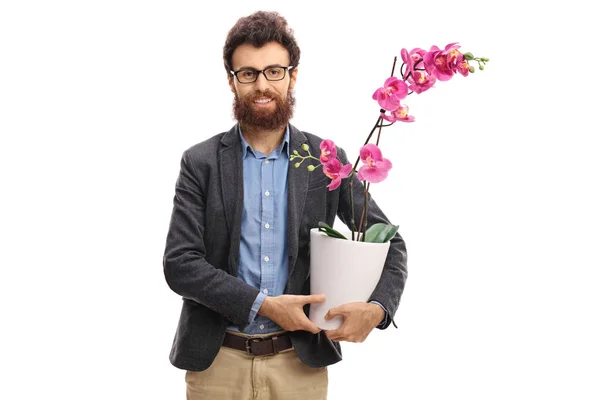 Man met een orchidee bloem in een pot — Stockfoto