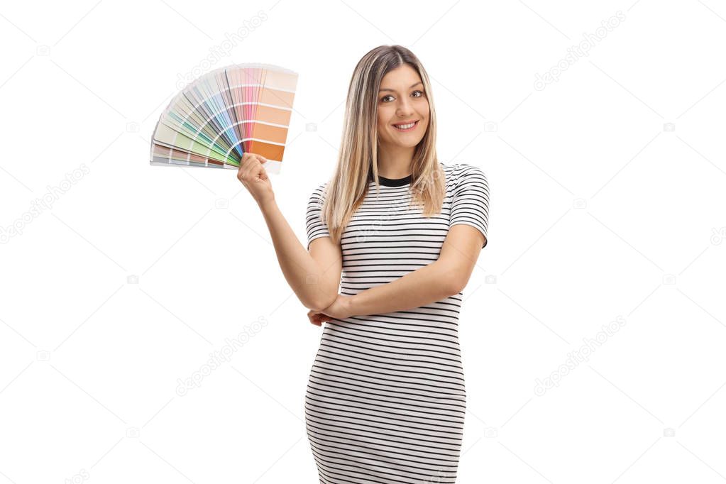 Pretty girl holding a color swatch and smiling