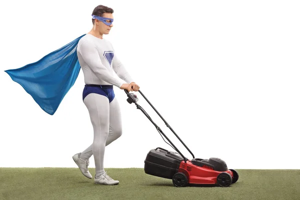 Superhero mowing with a lawnmower — Stock Photo, Image