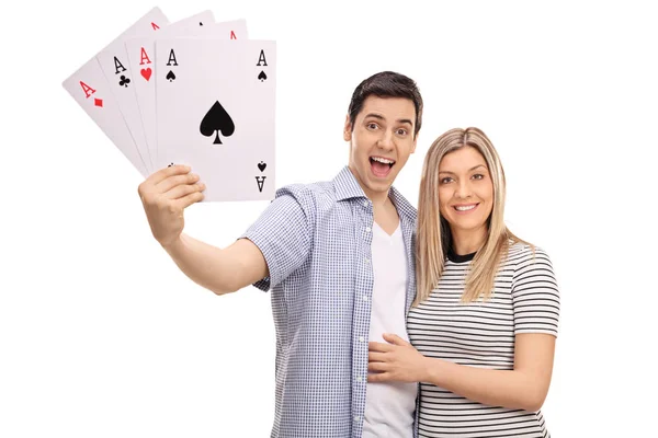 Cheerful couple with four aces playing cards — Stock Photo, Image