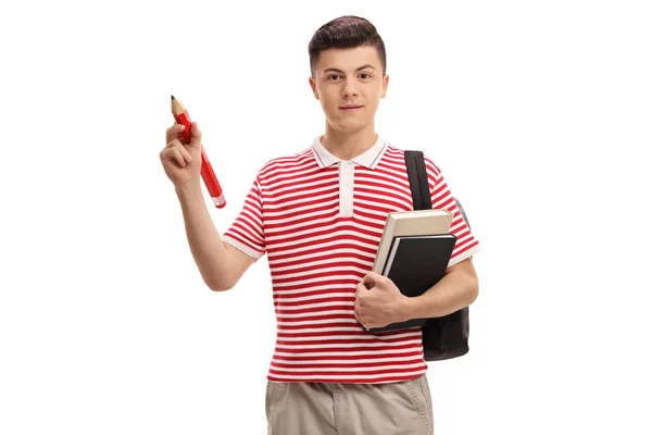 Estudante adolescente segurando um lápis e livros — Fotografia de Stock