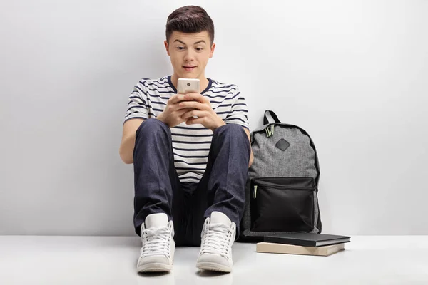 Teenage student using phone — Stock Photo, Image