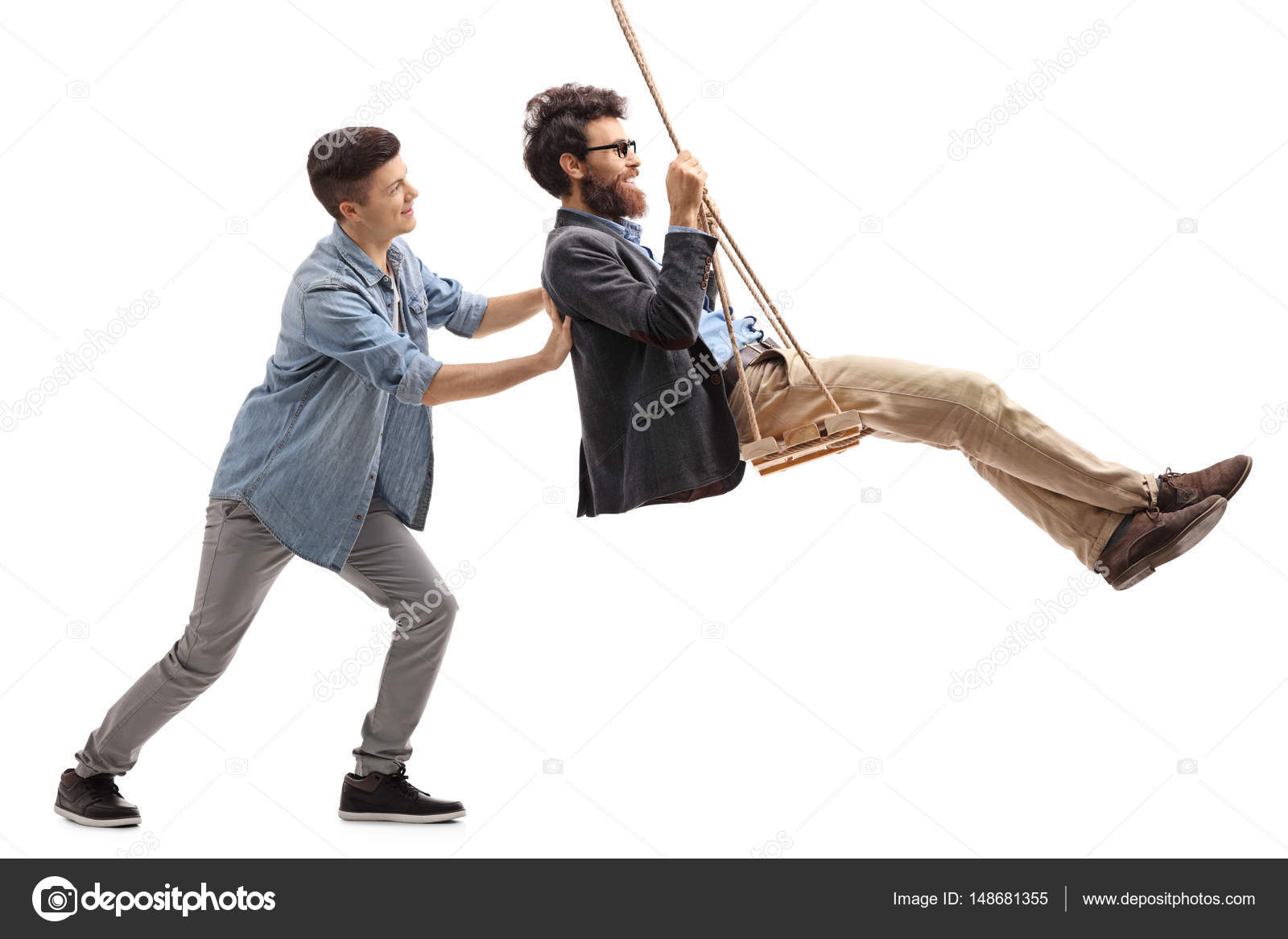 Son Pushing His Father On A Swing Stock Photo
