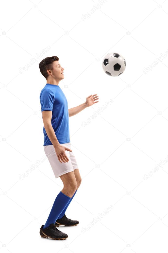 Teenage soccer player with a football