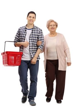 Guy with a shopping basket and a mature woman walking