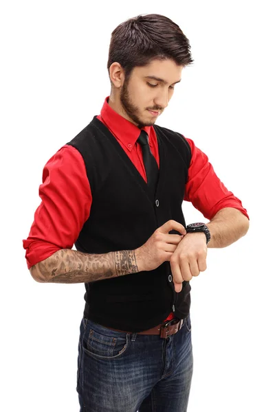 Tattooed man setting his watch — Stock Photo, Image