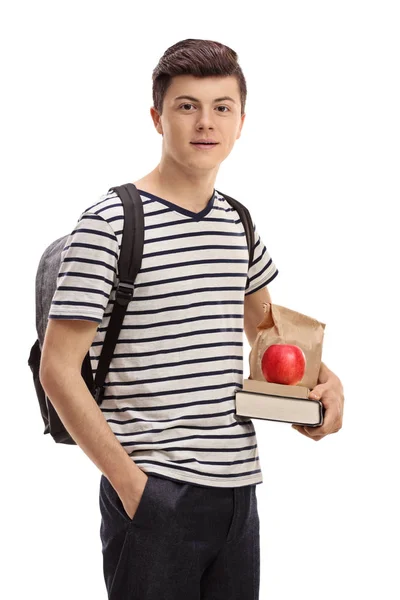 Estudante adolescente segurando livros e um lanche — Fotografia de Stock