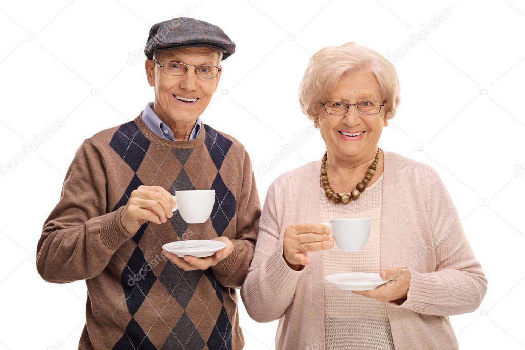 Seniors with cups looking at the camera and smiling