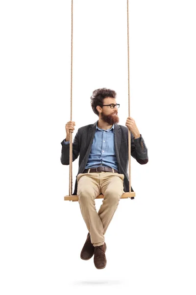 Man sitting on a swing and looking to the right — Stock Photo, Image