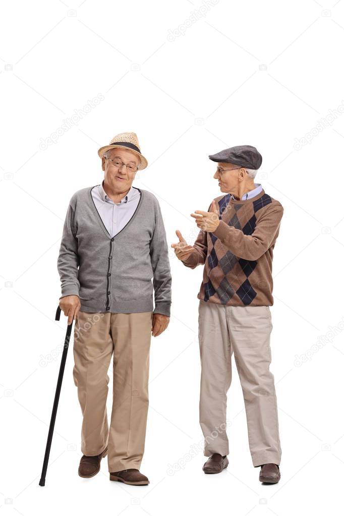 Two elderly men walking and talking