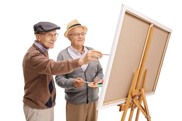Два пожилых человека рисуют на холсте — стоковое фото