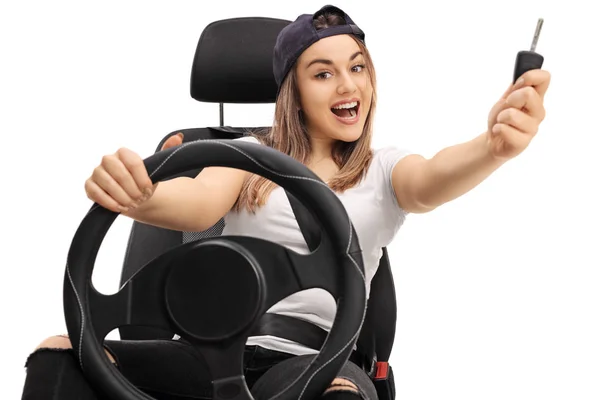 Girl with a car key sitting in a car seat — Stock Photo, Image