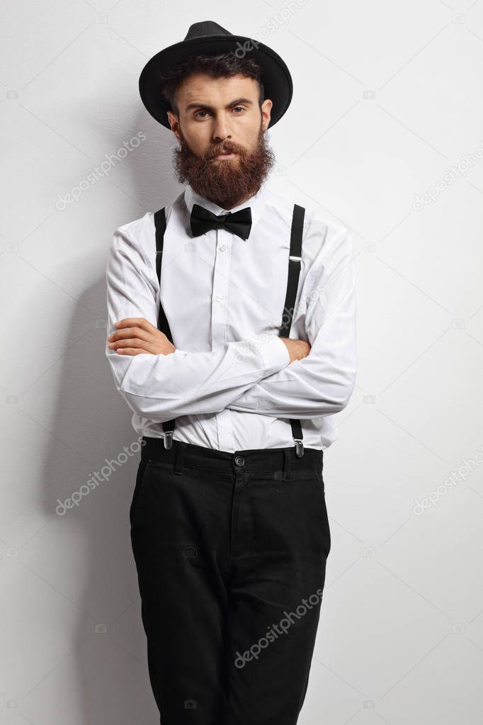 Bearded man with a bow tie and suspenders