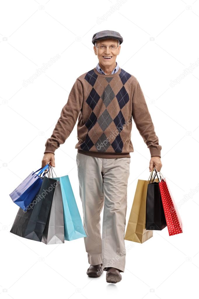 man carrying shopping bags and walking 