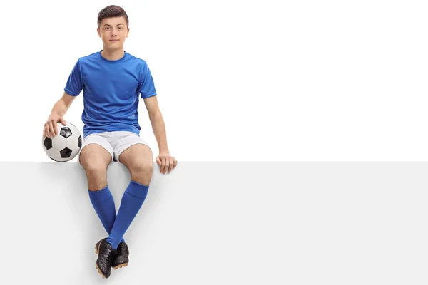 Jugador de fútbol adolescente sentado en un panel —  Fotos de Stock