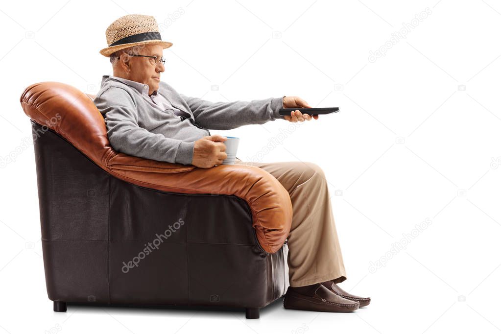 Bored elderly man watching television