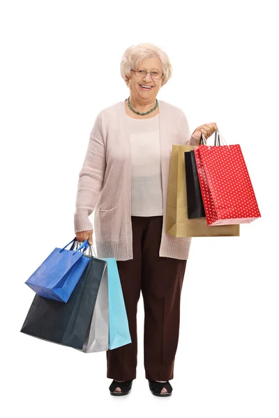 Äldre kvinna med kassar och påsar — Stockfoto