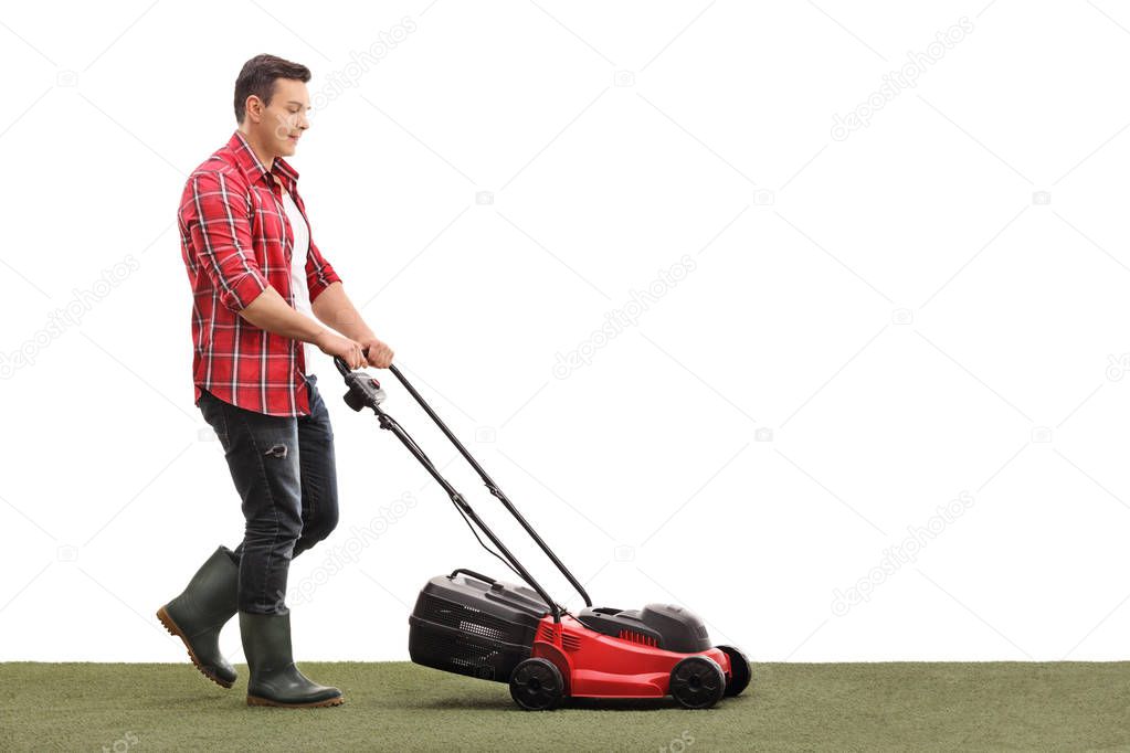Gardener mowing a lawn with a lawnmower