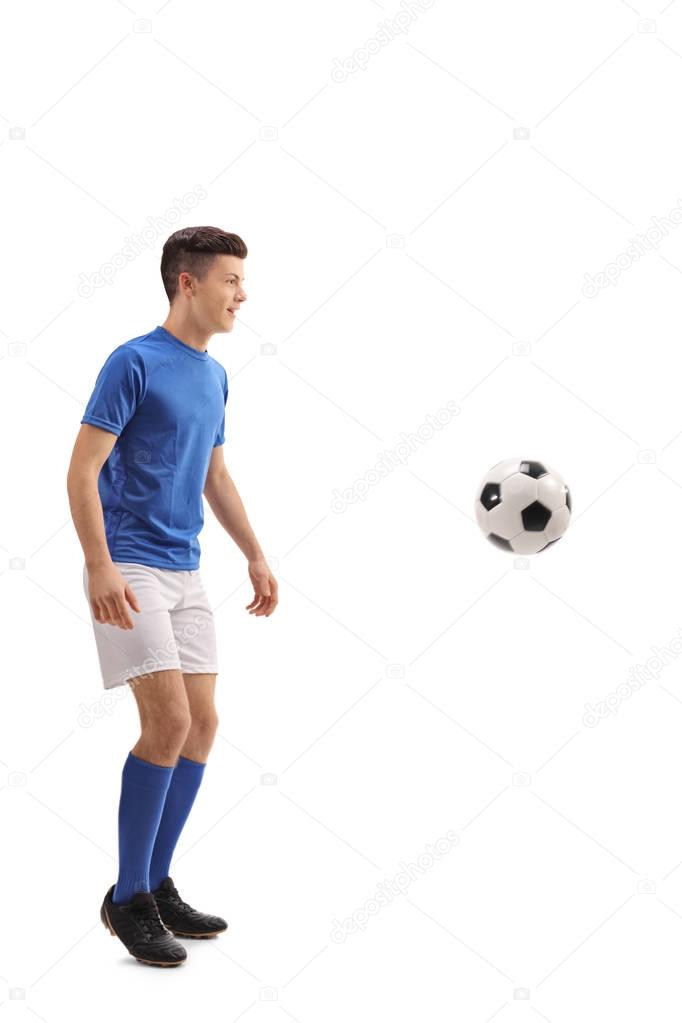 Teen soccer player with a football