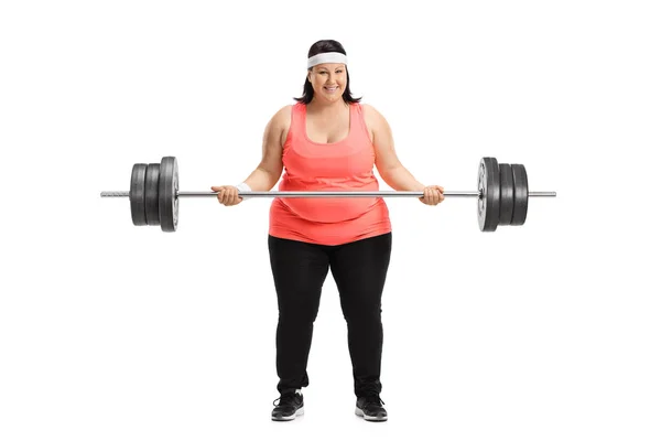 Mujer con sobrepeso levantando una gran mancuerna — Foto de Stock