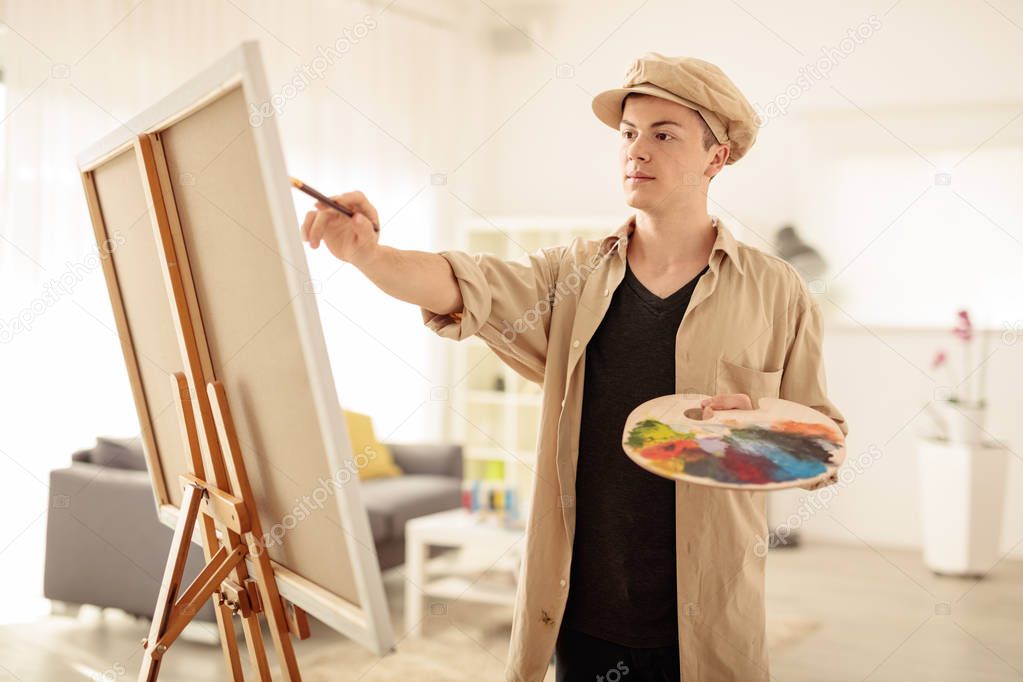 Teenage painter painting on a canvas