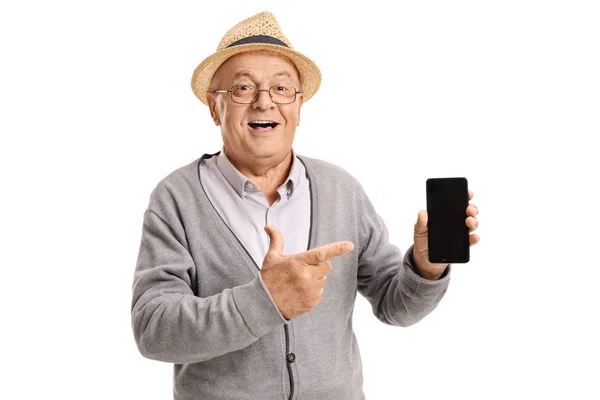 Mature man holding a phone and pointing — Stock Photo, Image