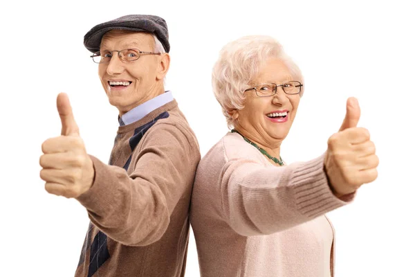 Cheerful seniors holding their thumbs up — Stock Photo, Image