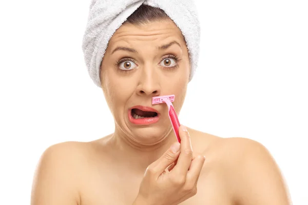 Shocked woman shaving her moustache — Stock Photo, Image