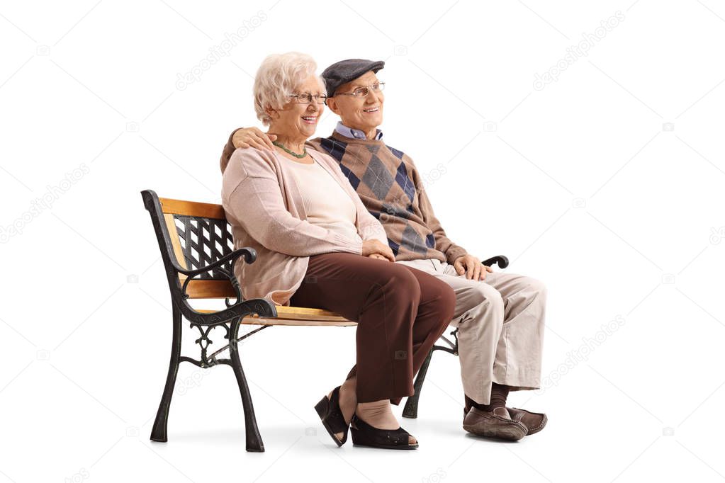 Senior couple sitting on a bench and looking away