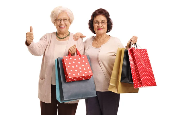 Donne con borse della spesa facendo pollice verso l'alto gesto — Foto Stock
