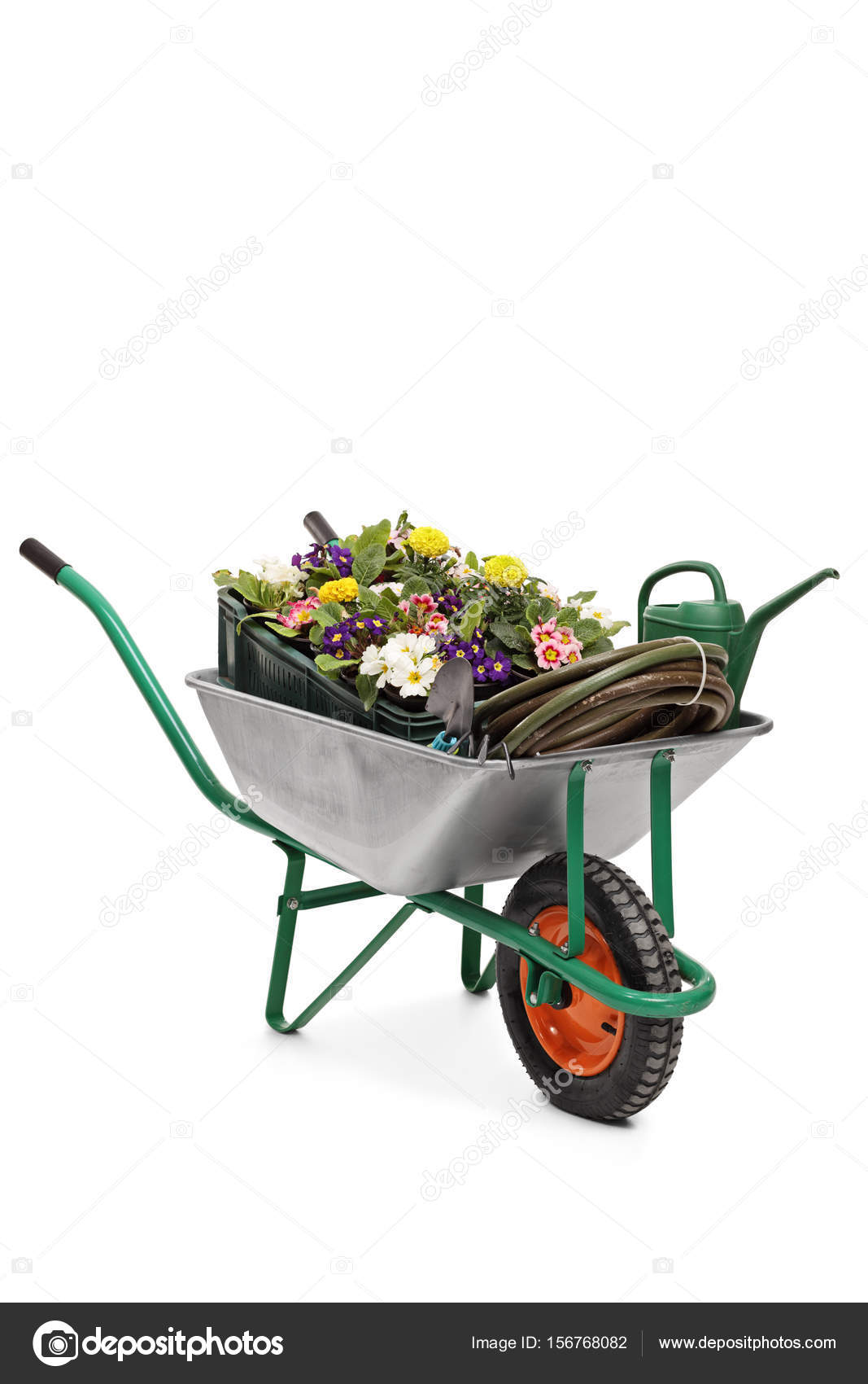 Wheelbarrow filled with flowers and gardening equipment Stock Photo by