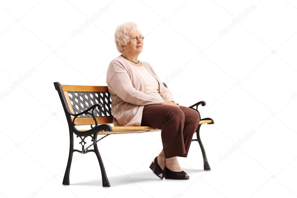 Elderly woman sitting on a bench and looking away