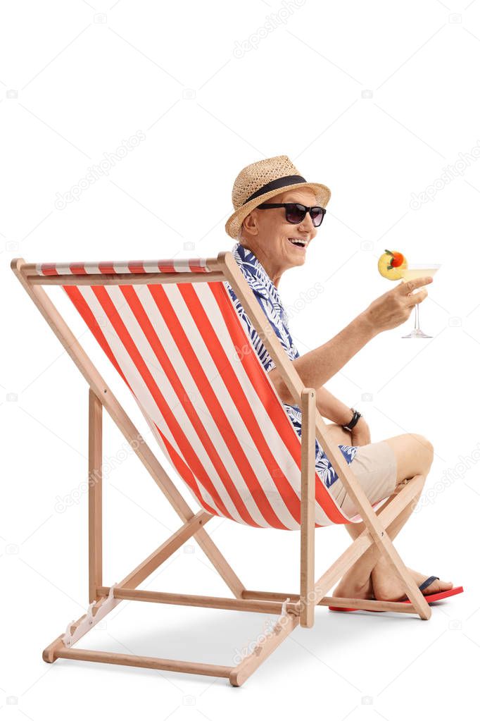 elderly tourist with a cocktail sitting in a deck chair
