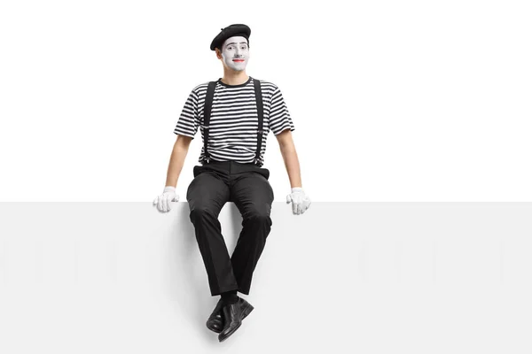 Mime artist sitting on a panel — Stock Photo, Image