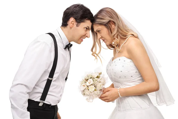 Furious newlywed couple pushing their heads — Stock Photo, Image