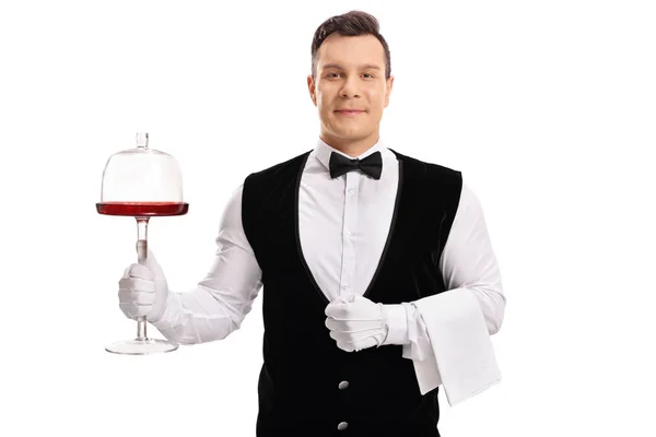 Waiter holding a cake server stand — Stock Photo, Image